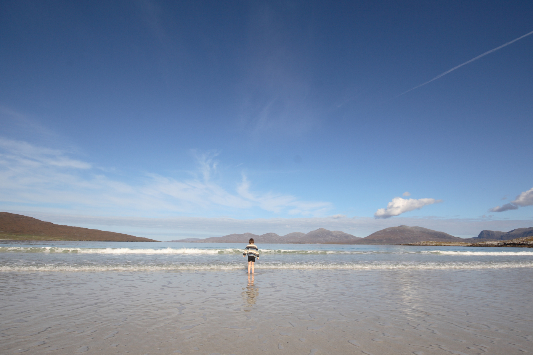 Boy on luskentyre beach Isle of Harris on a sunny day
