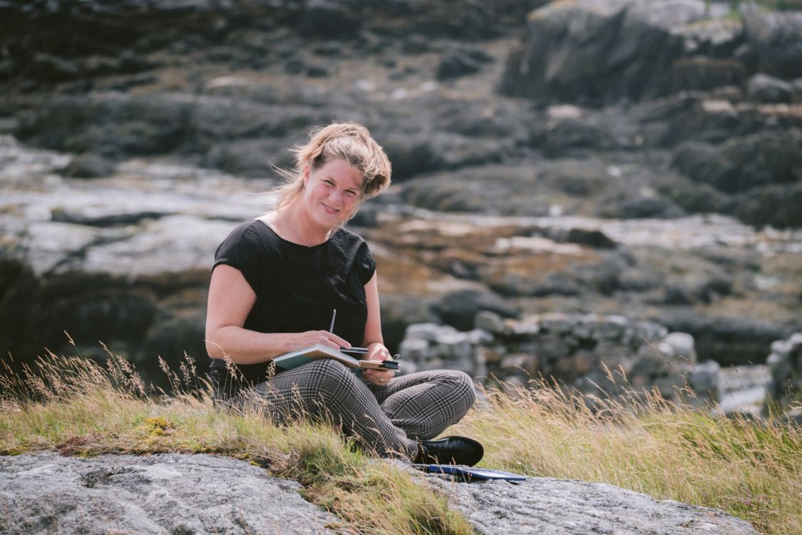 artist retreat leader sitting painting amongst the croft lands of the outer hebrides 