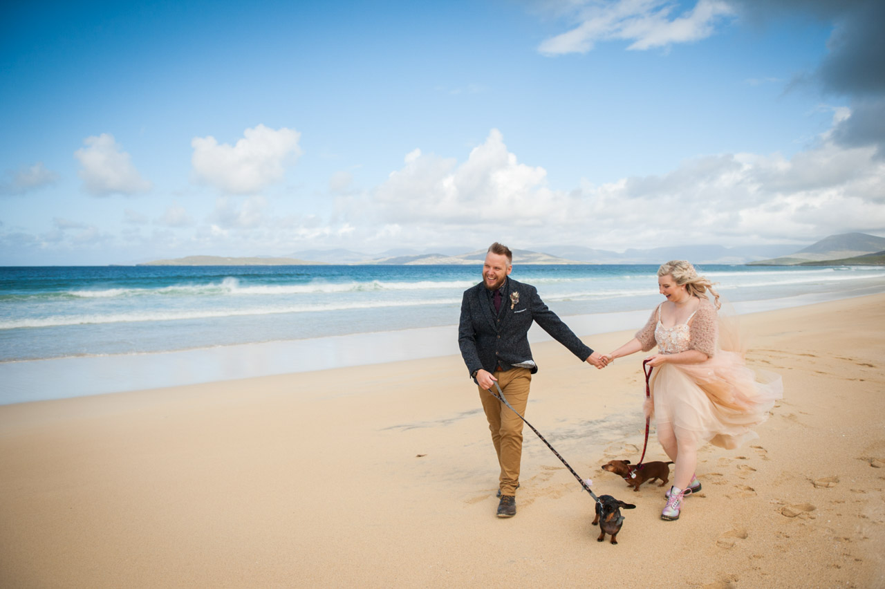 wedding couple with dog walking on scarista beach, outer hebrides 