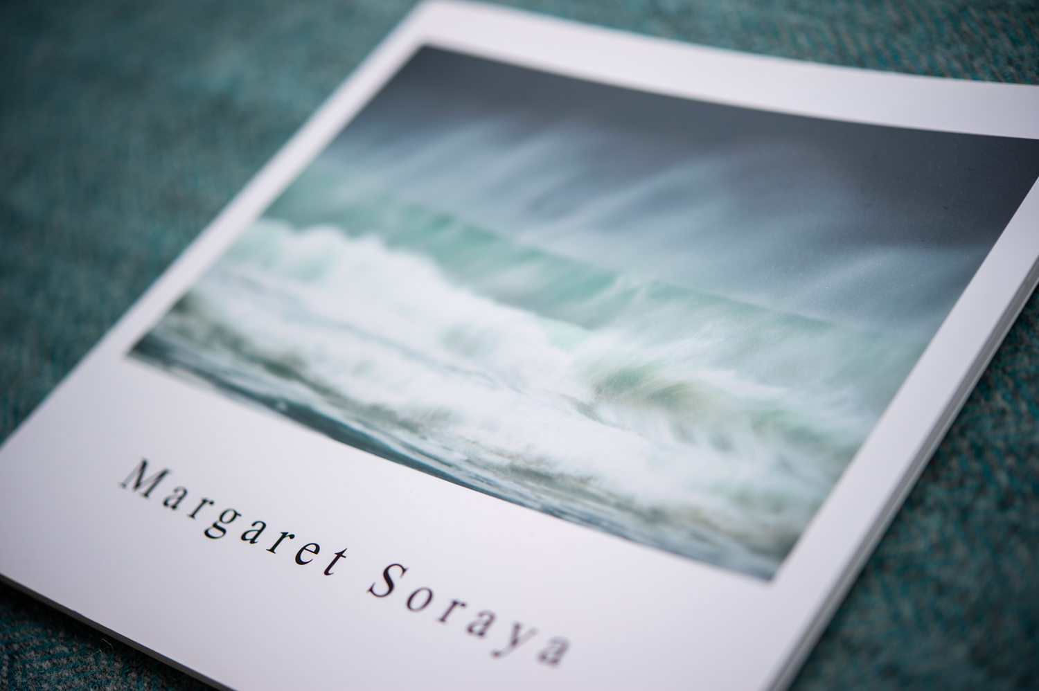 Quiet — Margaret Soraya photography book cover showing a stormy Hebridean wave in turquoise and grey, on Harris tweed