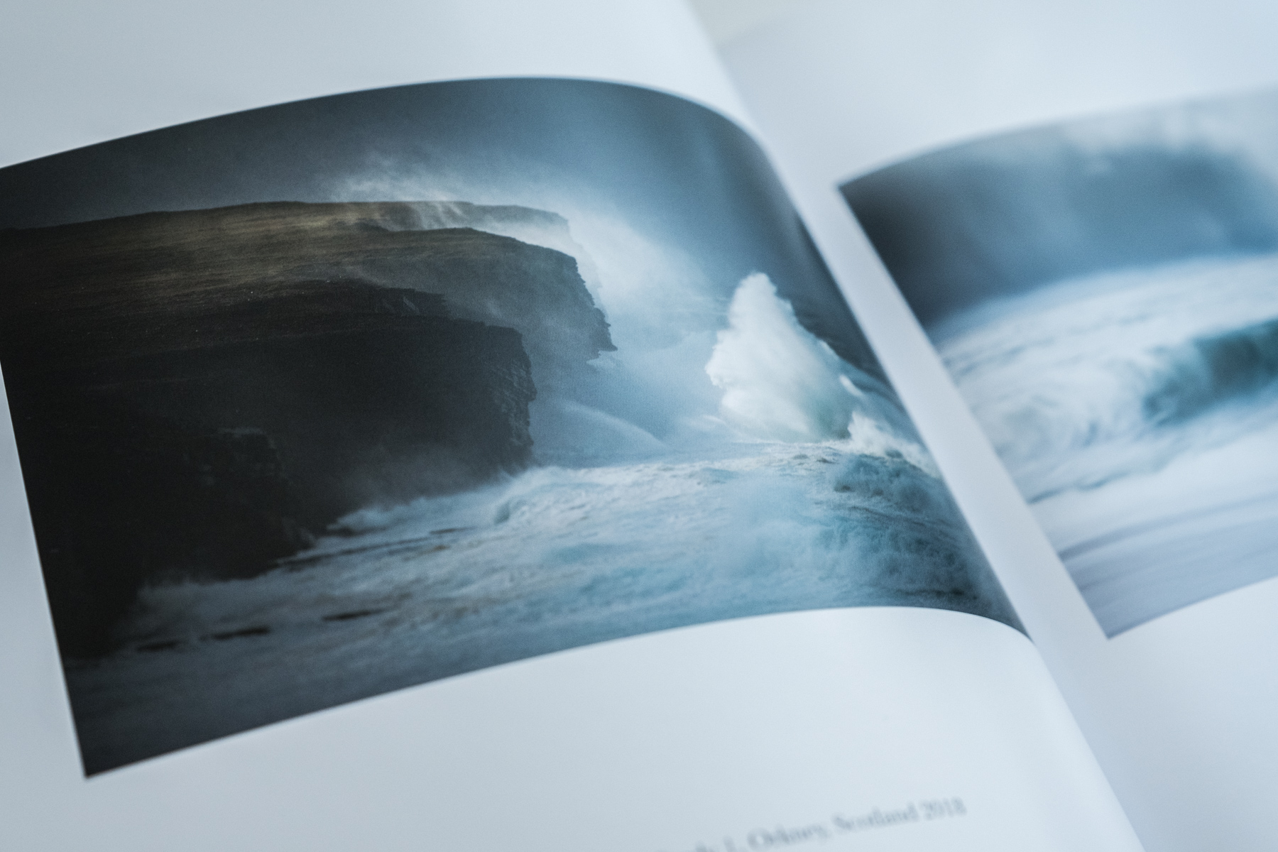 Inside spread of Quiet by Margaret Soraya showing a dramatic storm wave crashing against Orkney cliffs Scotland 2018