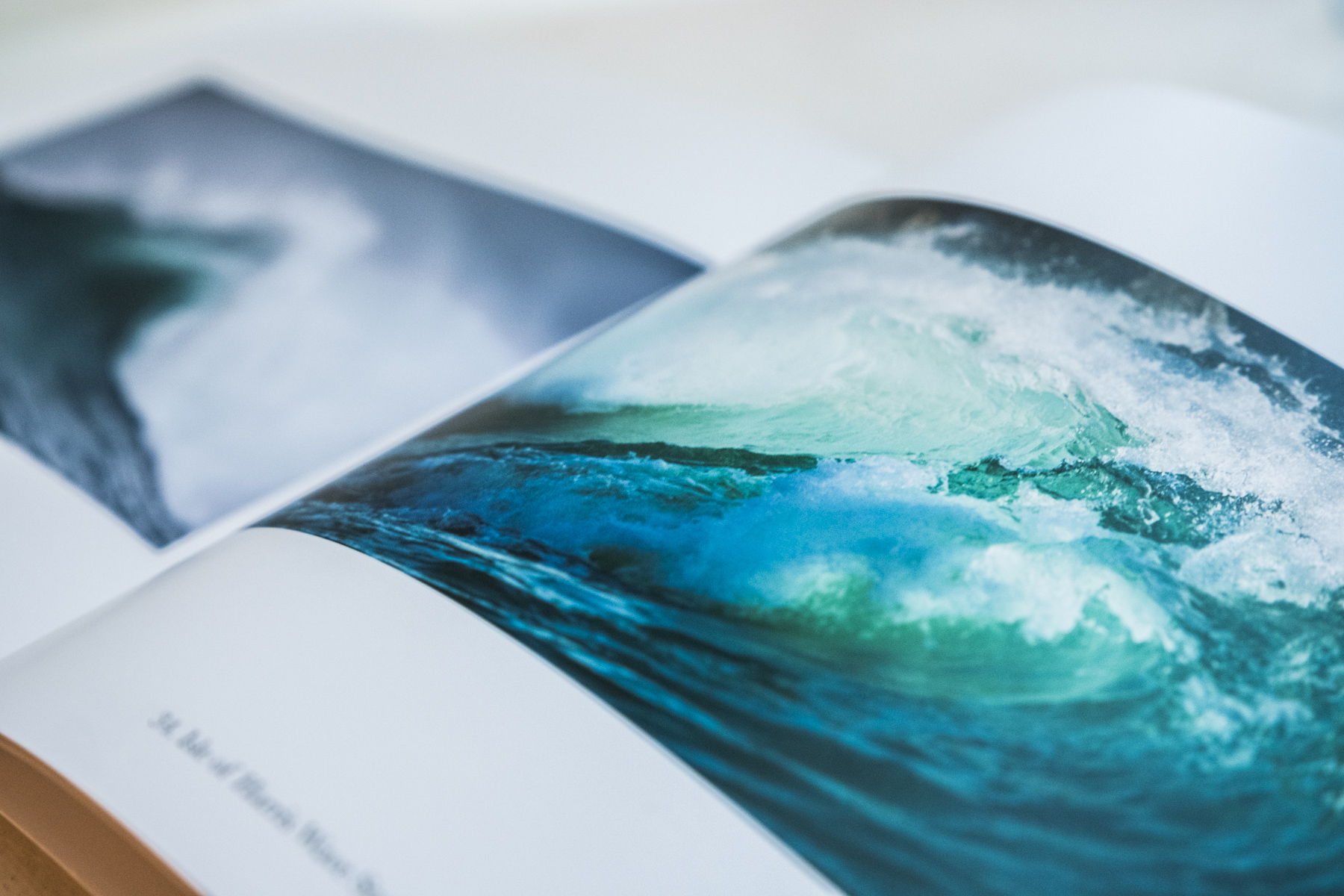 Open spread of Quiet by Margaret Soraya showing a dramatic full-bleed close-up of a breaking turquoise Hebridean wave