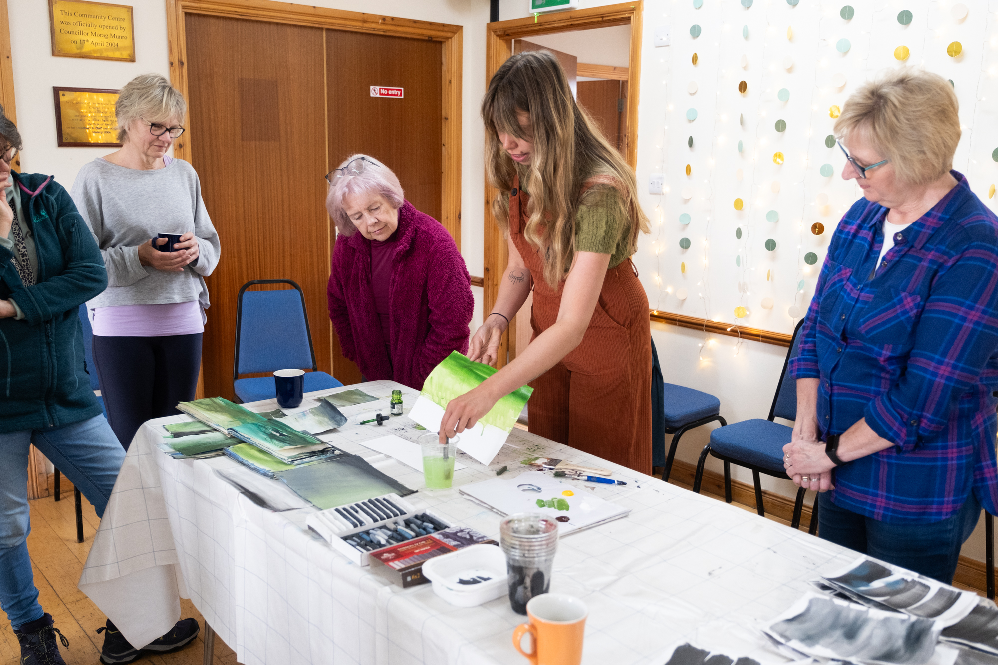 art group watching ellis oconnor do a painting demonstration